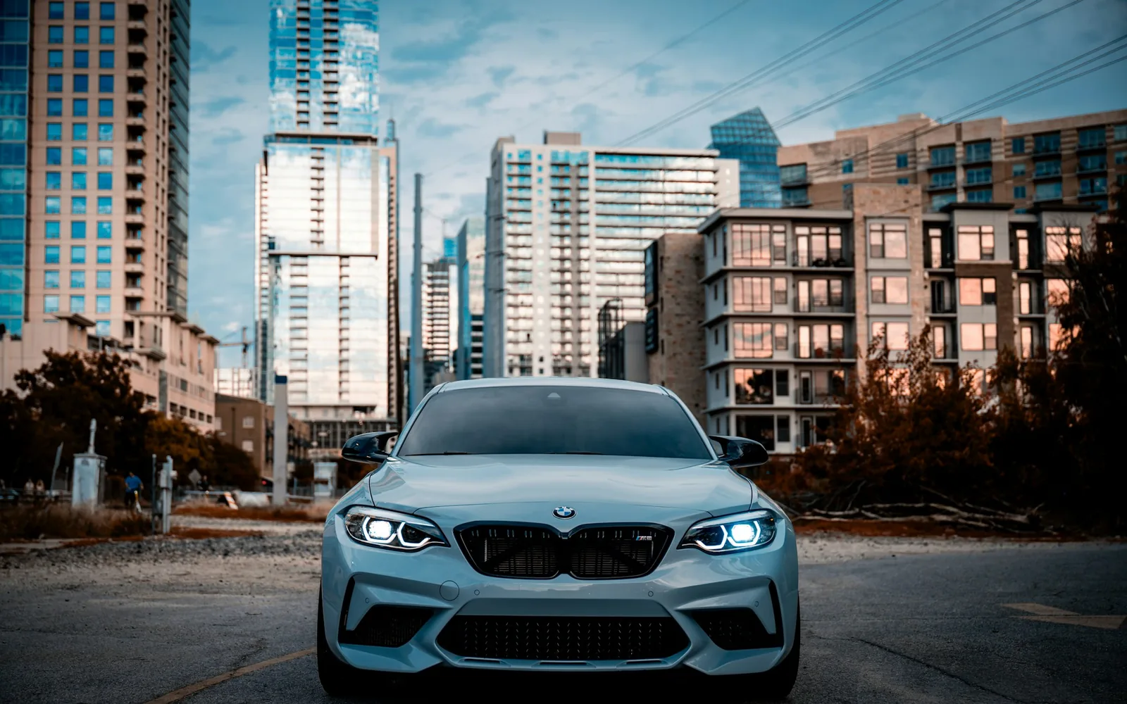 Silver BMW in front of glass towers (image)